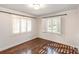 Cozy bedroom with hardwood floors and great natural light from window shutters at 1831 Jameston Dr, Charlotte, NC 28209