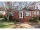 Charming brick home featuring a well-maintained yard and inviting front entrance at 1831 Jameston Dr, Charlotte, NC 28209