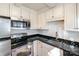 Well-equipped kitchen with stainless steel appliances and black countertops at 1831 Jameston Dr, Charlotte, NC 28209