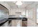 Bright kitchen featuring white cabinetry, stainless steel appliances, and ample counter space at 1831 Jameston Dr, Charlotte, NC 28209