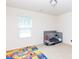 Brightly lit bedroom with colorful playmat and gray baby crib at 1953 Boulder Ct, Gastonia, NC 28054