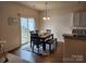 Cozy dining area with a dark wood table, seating for six, and natural light from the sliding door at 1953 Boulder Ct, Gastonia, NC 28054