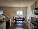 Bright dining area with modern lighting, a dark table with seating for six, and a view to the backyard at 1953 Boulder Ct, Gastonia, NC 28054