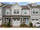 Attractive townhome with a stone facade, a white garage door, and a distinctive light blue front door at 2004 Crooked Oak Ln, York, SC 29745