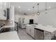 Open concept kitchen seamlessly connects to living area, featuring stainless steel appliances, island and modern lighting at 2004 Crooked Oak Ln, York, SC 29745