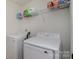 Bright laundry room equipped with modern washer and dryer, featuring shelving for organized storage at 2004 Crooked Oak Ln, York, SC 29745