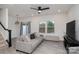 Comfortable living room with gray sofa, ceiling fan, large windows, and access to the backyard at 2004 Crooked Oak Ln, York, SC 29745