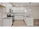 Modern kitchen featuring white cabinets, stainless steel appliances, and granite countertops at 2104 Clapham Ct, Charlotte, NC 28215