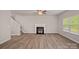 Inviting living room featuring a fireplace, a staircase, and light wood floors at 2104 Clapham Ct, Charlotte, NC 28215