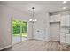 Bright living space with sliding door, light wood floors, and built in cabinets at 2104 Clapham Ct, Charlotte, NC 28215
