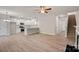 Open-concept living space with light wood floors, white kitchen, and a staircase at 2104 Clapham Ct, Charlotte, NC 28215
