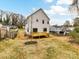 View of the rear of the house highlighting a wooden deck, and partially seeded backyard and fencing at 2615 Brentwood Pl, Charlotte, NC 28208