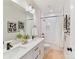 A modern bathroom featuring a dual sink vanity, a white tiled shower and modern fixtures at 2615 Brentwood Pl, Charlotte, NC 28208