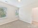 A bedroom with carpet flooring, natural light from two windows, and neutral walls at 2615 Brentwood Pl, Charlotte, NC 28208