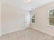 Bright bedroom with neutral carpet flooring, window and neutral paint at 2615 Brentwood Pl, Charlotte, NC 28208