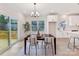 Elegant dining space with a modern chandelier, a view of the backyard deck, and natural light at 2615 Brentwood Pl, Charlotte, NC 28208
