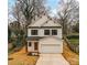 Charming two-story home with white siding, black window trim, and attached garage at 2615 Brentwood Pl, Charlotte, NC 28208