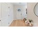 Clean and bright hallway with wood floors leading to a staircase and front door at 2615 Brentwood Pl, Charlotte, NC 28208