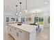 Open concept kitchen with white cabinetry, island with seating, and adjacent dining area at 2615 Brentwood Pl, Charlotte, NC 28208