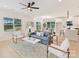 Bright and open living area with a modern ceiling fan and seamless flow to the dining area at 2615 Brentwood Pl, Charlotte, NC 28208