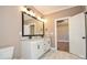 Bathroom featuring double sink vanity, marble tile floor, and framed mirror with views to bedroom at 2622 Old Camden Rd, Monroe, NC 28110