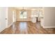 Open concept dining area with natural light, modern lighting fixture, and access to the kitchen at 2622 Old Camden Rd, Monroe, NC 28110