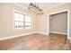 Dining room with hardwood floors, large window, and modern light fixture at 2622 Old Camden Rd, Monroe, NC 28110