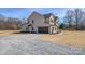 Wide view of home exterior with attached garage, gravel driveway, and well kept landscaping at 2622 Old Camden Rd, Monroe, NC 28110
