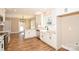 Bright kitchen boasts a farmhouse sink, stainless steel appliances, and an island with granite countertops at 2622 Old Camden Rd, Monroe, NC 28110