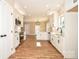 Kitchen featuring hardwood floors, white cabinets, stainless steel appliances, and island at 2622 Old Camden Rd, Monroe, NC 28110