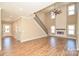 Modern living room with a fireplace, staircase, and tall ceilings, creating a spacious and inviting area at 2622 Old Camden Rd, Monroe, NC 28110