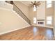 Modern living room featuring a staircase, fireplace, and tall ceilings, creating a stylish space at 2622 Old Camden Rd, Monroe, NC 28110