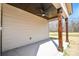Covered patio with ceiling fan and stained wood columns at 2622 Old Camden Rd, Monroe, NC 28110