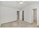 A bright bedroom featuring closet and bathroom entrances and a window at 2944 Caldwell Ridge Pkwy, Charlotte, NC 28213