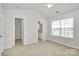 A carpeted bedroom featuring closet and bathroom entrances and a window at 2944 Caldwell Ridge Pkwy, Charlotte, NC 28213