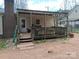 The home has a covered wooden deck area, ideal for outdoor dining, entertainment, and relaxing at 303 Ellenwood Dr, Albemarle, NC 28001