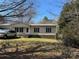 Charming single-story home with classic siding, black shutters, and a well-maintained front lawn at 303 Ellenwood Dr, Albemarle, NC 28001