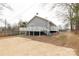 Photo showcasing the backyard with a concrete pad, wooden fence, and elevated deck with stairs at 305 Flat Rock St, Clover, SC 29710