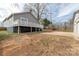 View of the backyard with an elevated deck, concrete pad and fenced perimeter at 305 Flat Rock St, Clover, SC 29710