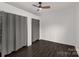 A bedroom is shown with wood-look flooring, ceiling fan, and closet at 305 Flat Rock St, Clover, SC 29710