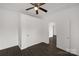 Minimalist bedroom with neutral walls, dark floors, and a ceiling fan at 305 Flat Rock St, Clover, SC 29710
