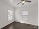 Bright bedroom with neutral walls, dark floors, and a modern ceiling fan at 305 Flat Rock St, Clover, SC 29710