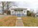 Charming single-story home with a welcoming front porch and mature trees at 305 Flat Rock St, Clover, SC 29710
