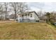 An eye-level view of a single-story home with light gray siding and a modest front yard at 305 Flat Rock St, Clover, SC 29710