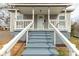 Close-up view of the home's front porch showcasing the painted stairs and white railings at 305 Flat Rock St, Clover, SC 29710