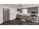 Updated kitchen with stainless steel appliances, gray cabinets, and wood-look floors at 305 Flat Rock St, Clover, SC 29710