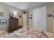 Cozy bedroom with neutral walls, a large dresser, and a patterned quilt on the bed at 333 Dudley Dr, Fort Mill, SC 29715