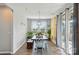 Dining room with a rustic table, modern chandelier, and sliding glass doors at 333 Dudley Dr, Fort Mill, SC 29715