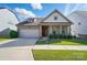 Charming single-story home featuring a two-car garage, landscaped front yard, and welcoming red front door at 333 Dudley Dr, Fort Mill, SC 29715