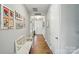 Bright hallway with wood floors, framed pictures, and a bench at 333 Dudley Dr, Fort Mill, SC 29715